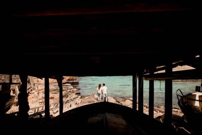 Amorous couple hugging on coastal pier