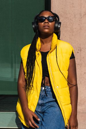 Trendy female listening to music on street