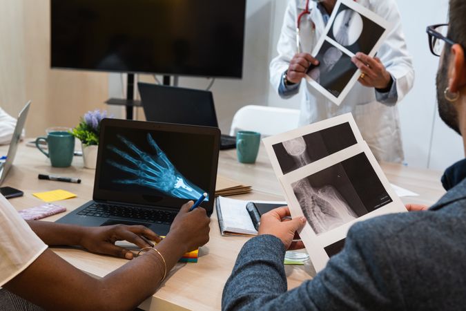 Crop doctors examining x rays in clinic