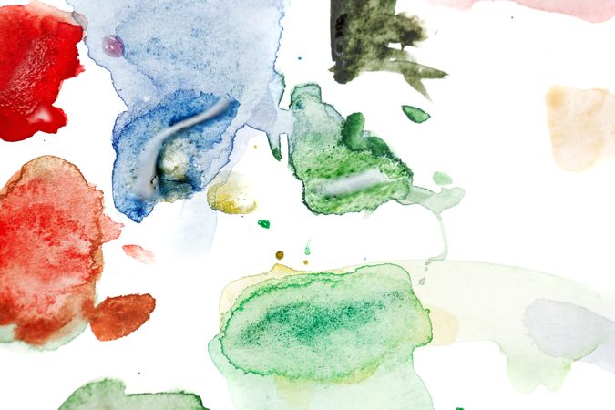 Watercolor drops of paint on paper with muted colors