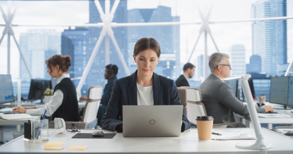 Professional Female Business Development Manager Typing On Laptop Computer In Bright Skyscraper Office In Downtown.
