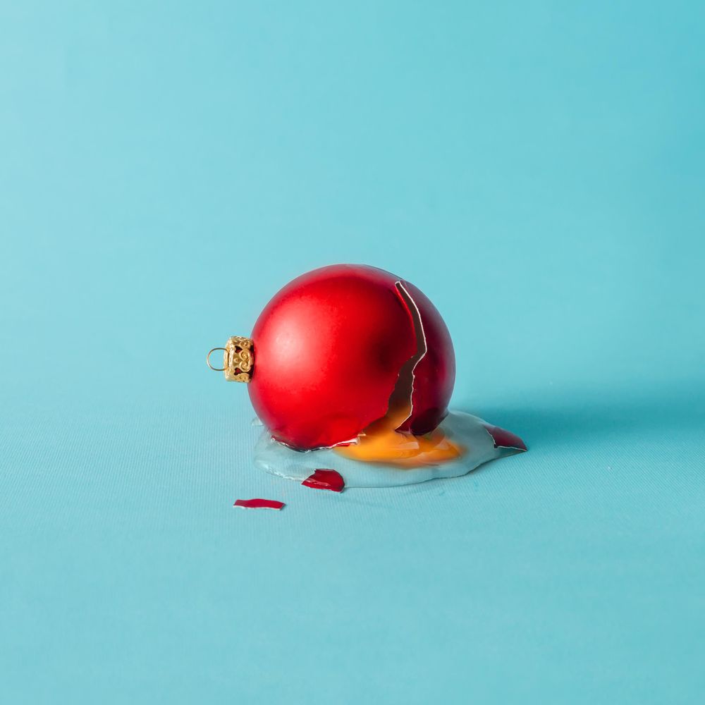 Broken Christmas bauble decoration cracked like a egg with yoke