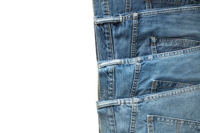 Jeans of different colors isolated on light background, space for text