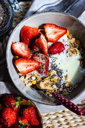 Close up of bowl of oatmeal, chia seeds and strawberry