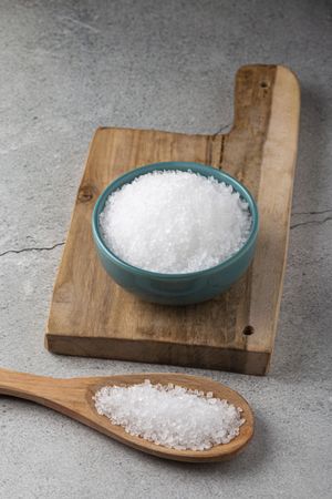Bowl with coarse salt on the table.