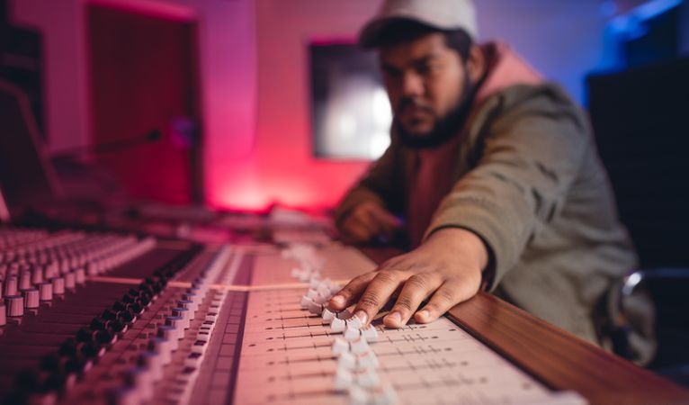 Focus on young man hands working on music mixer