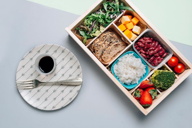 Food box with diet ingredients by copybook and plate