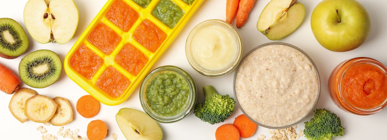 Composition with baby food on plain background, top view