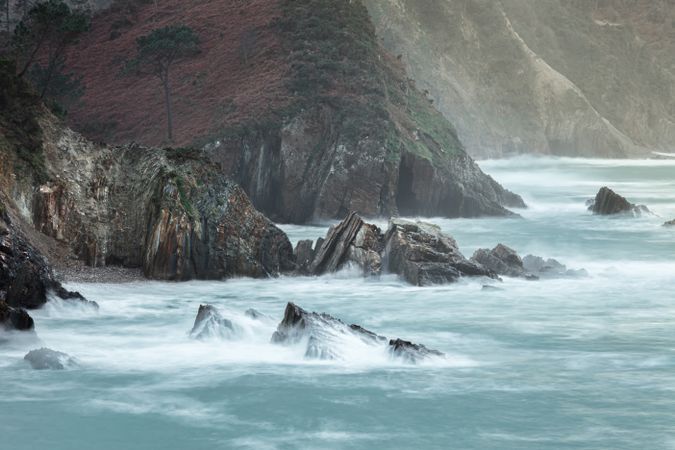 Storm with blustering waves on rocky coast