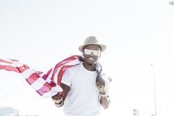Cheerful black man with American flag