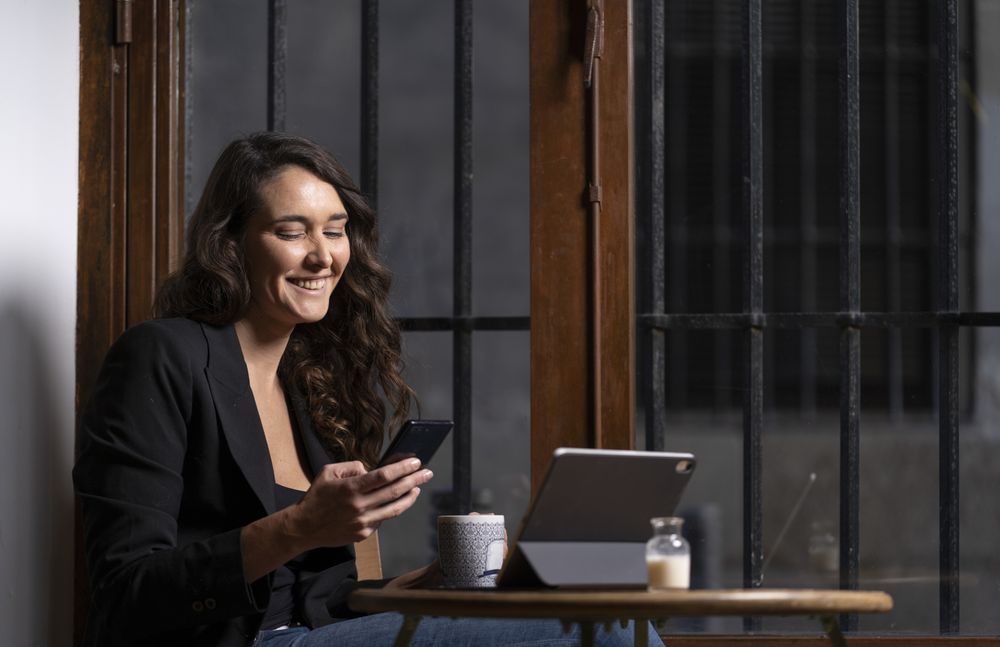 Young female using a mobile phone in cafe