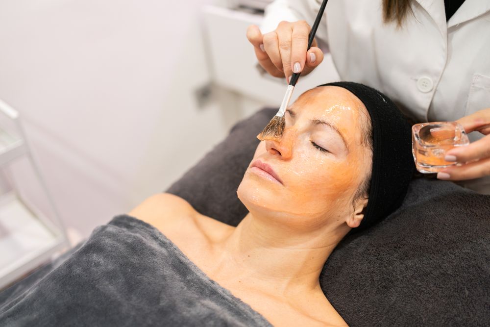 Woman receiving facial in spa