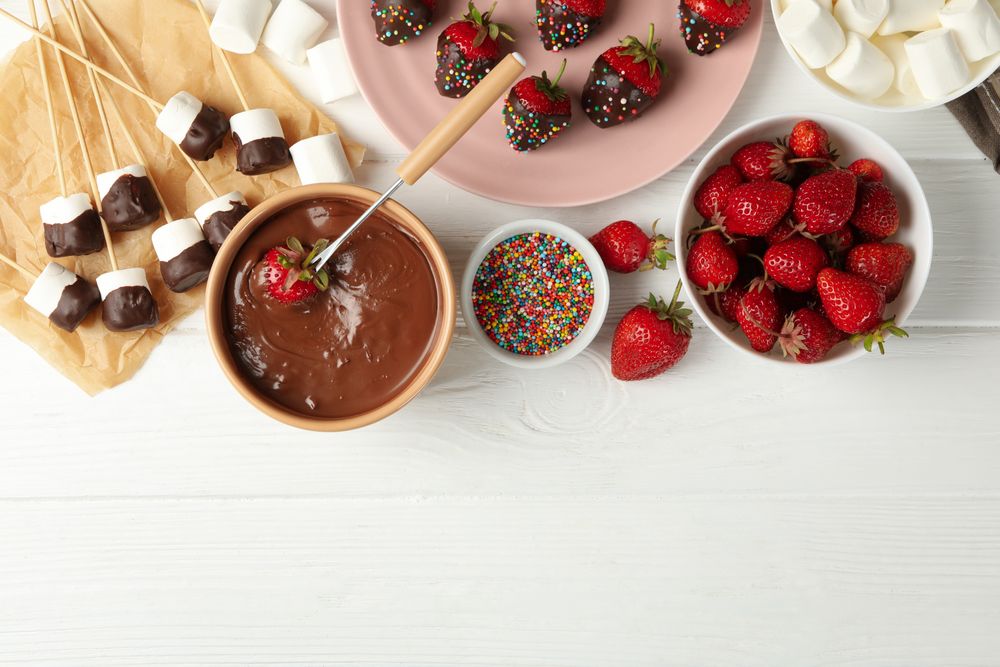 Composition with strawberry and marshmallow in chocolate, top view. Chocolate fondue