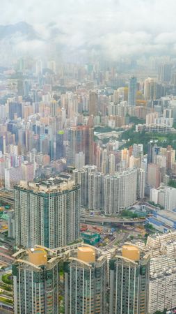 Aerial view of city buildings under foggy sky