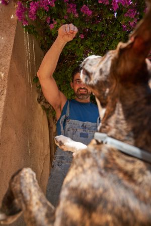 Happy man playing with dog outside