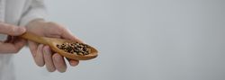 Man holding spoon with grains