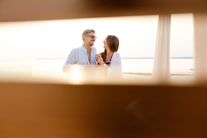 Happy couple standing on balcony and embracing each other