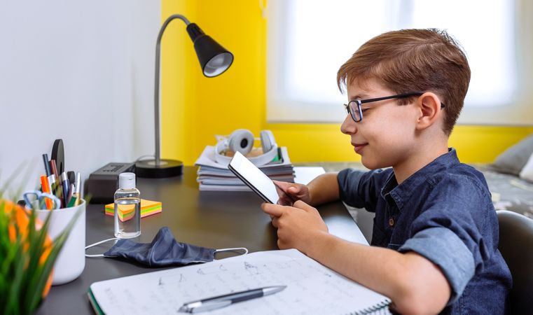 Teenager doing homework with a tablet