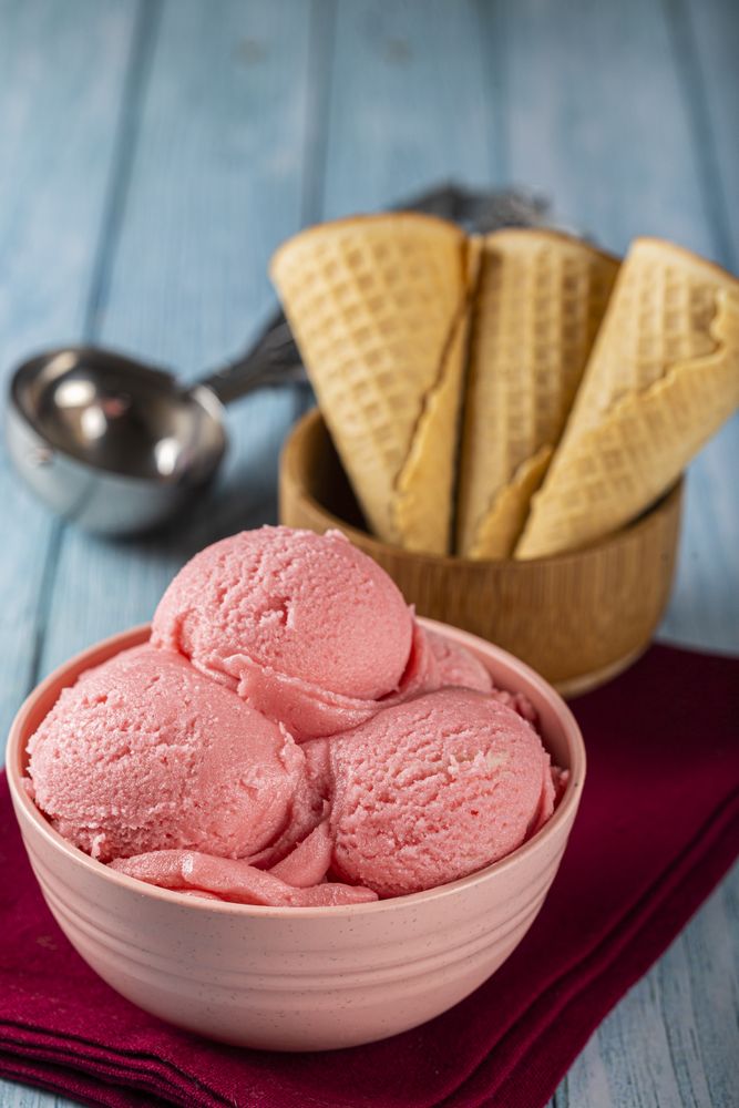 Bowl with strawberry ice cream balls.