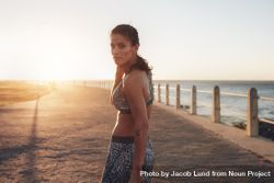 Female athlete on a seaside promenade at sunset 4ZaLA5