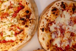Overhead portrait of several pizzas