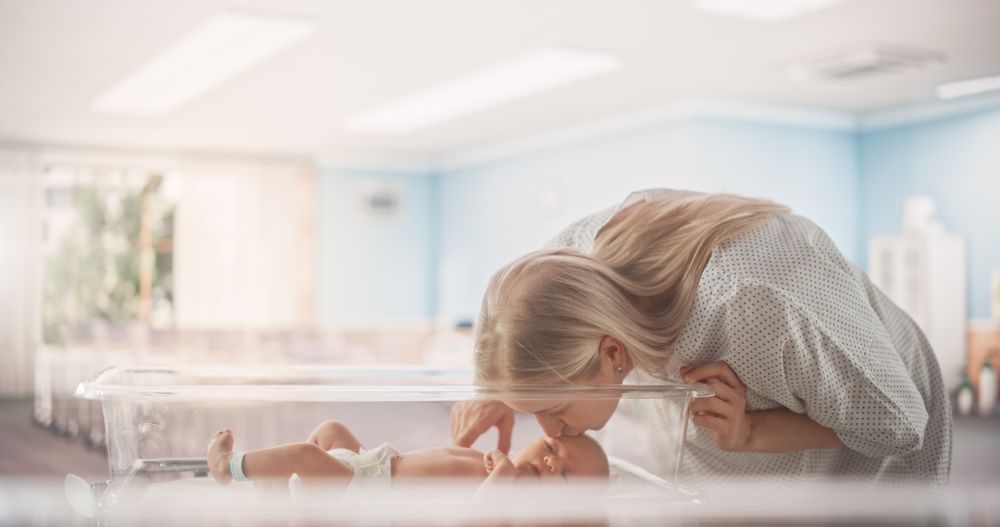 Beautiful Mother Checking Up on Her Newborn Baby in a Maternity Medical Ward Facility.