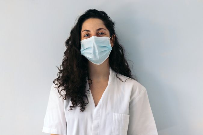 portrait of a female nurse smiling with mask