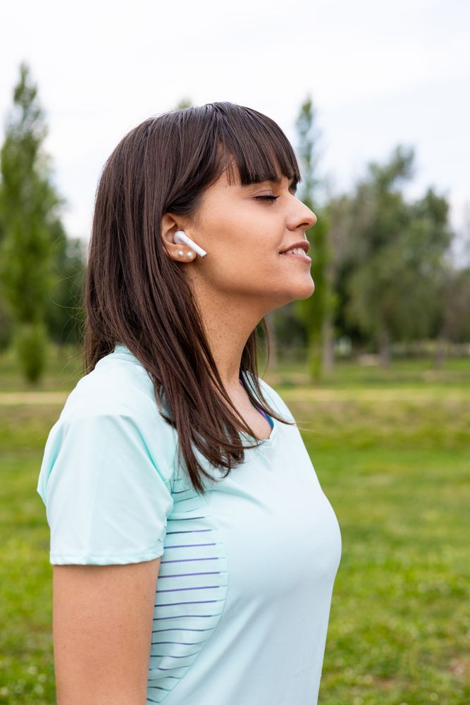Runner woman relaxed listening to music for training outdoors