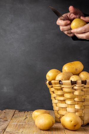 Person peeling potato