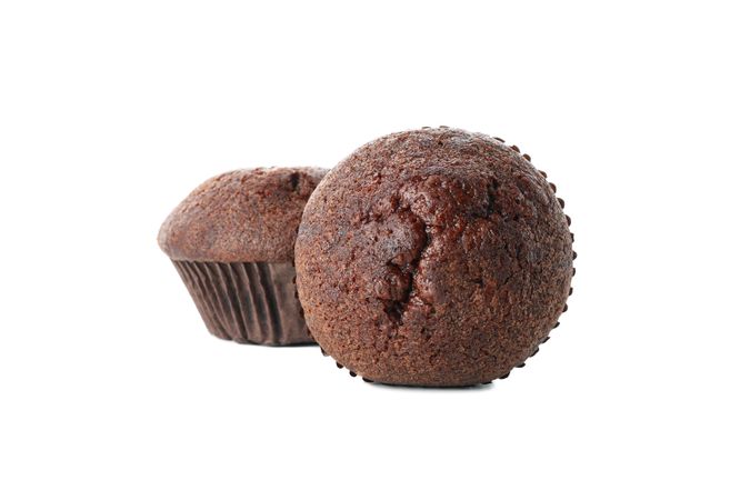 Delicious chocolate muffins isolated on blank background