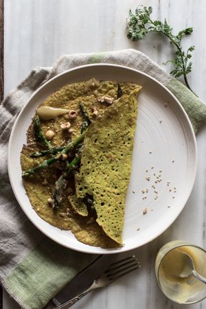 Served vegetarian crepe with oats and asparagus