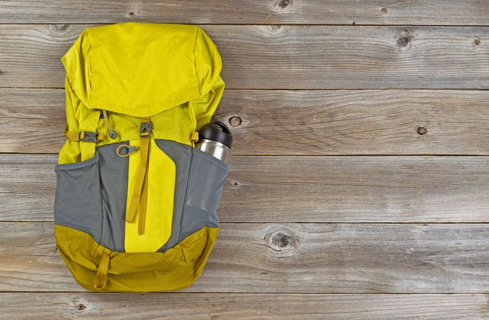 Weather proof backpack for hiking on rustic wood
