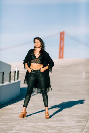 Trendy female standing on urban background