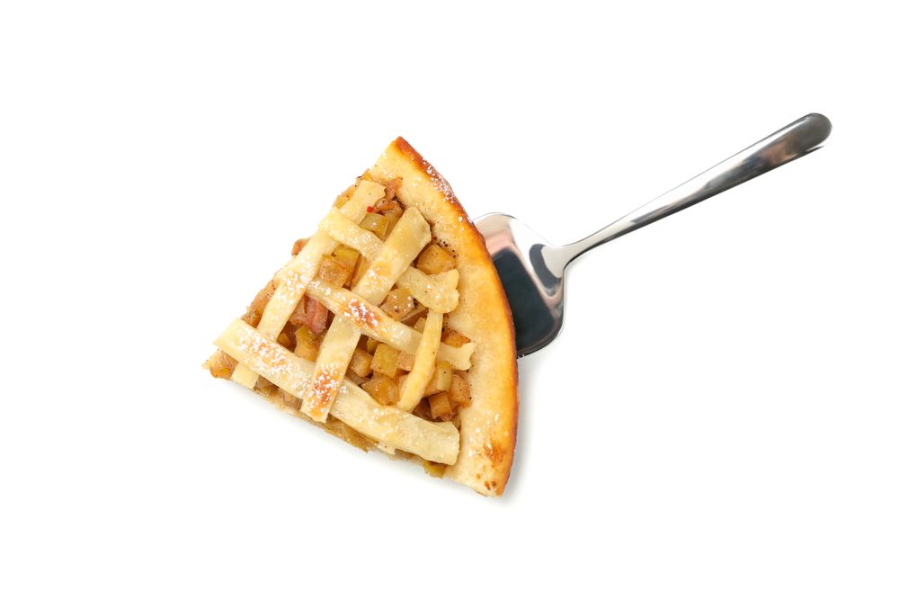Shovel with piece of tasty apple pie isolated on plain background