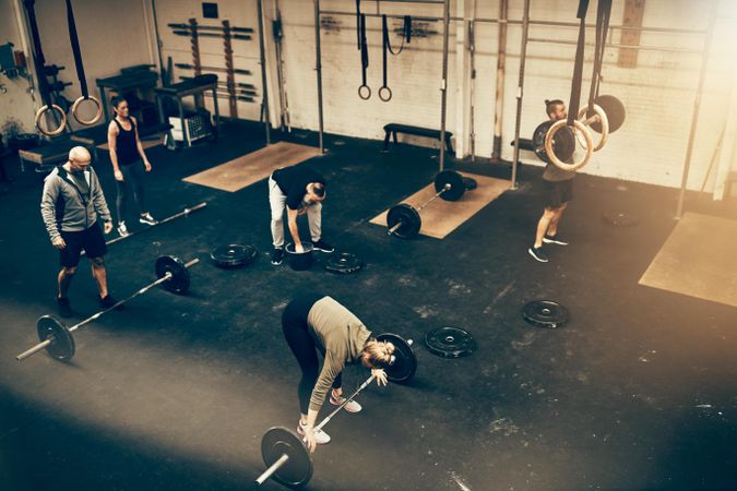 Group of people working out in weightlifting gym