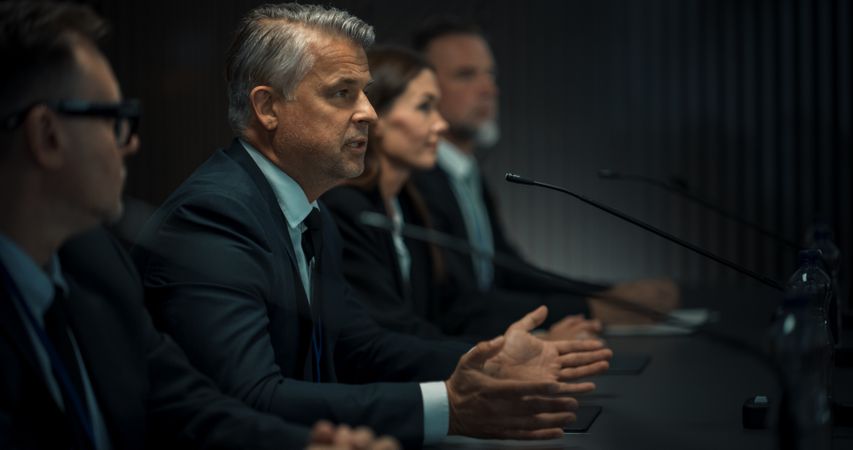 Male Head Of Political Delegation Speaking At International Economic Forum Press Conference.