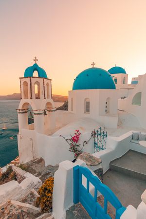 Blue domes and gate of Santorini over the Aegean Sea, vertical