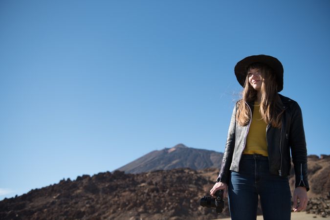 Woman with camera in desert