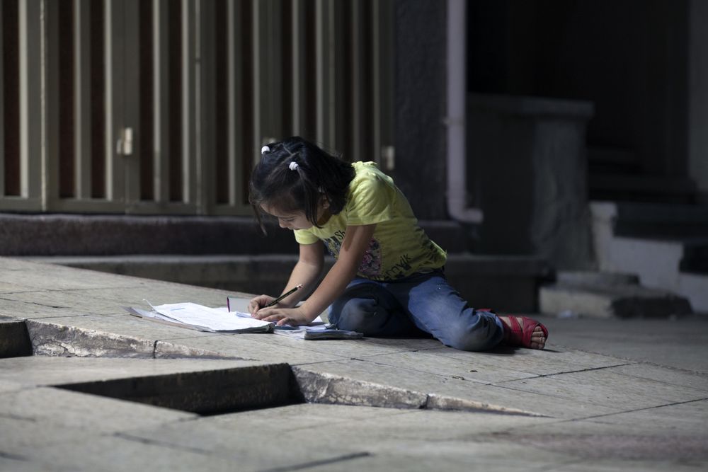 Child studying using street light