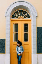 Stylish female by yellow door