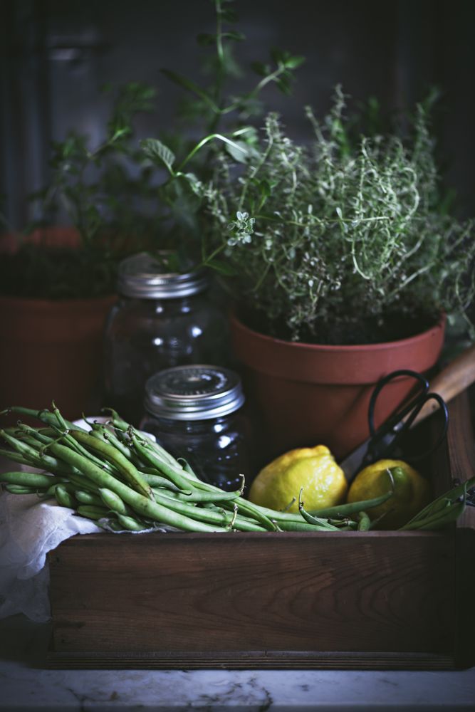 Fresh green vegetables with fruits and glass jars