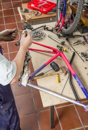 Real bicycle mechanic cleaning bike parts