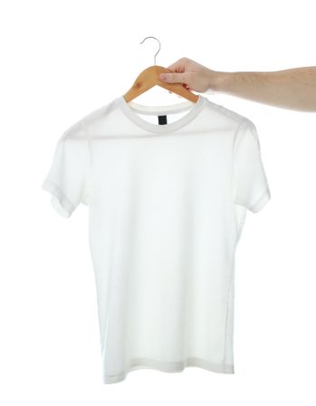 Man holds a hanger with blank t-shirt, isolated on plain background