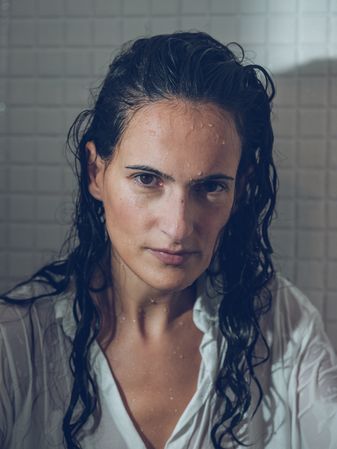Sopping dressed brunette in bathroom