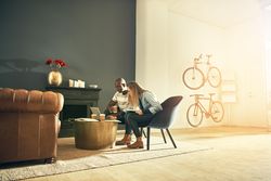 Male and female colleagues focused on laptop in modern workspace