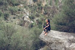 Glad female tourist admiring highlands