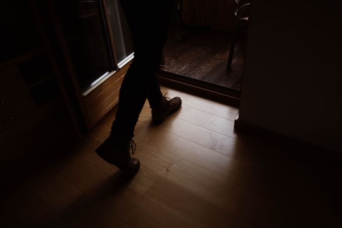 Male traveler in casual wear walking at home