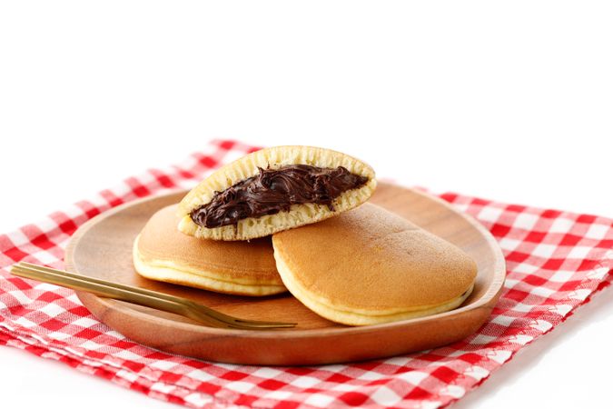 Fresh dorayaki pancakes filled with chocolate from Japan served on checkered napkin