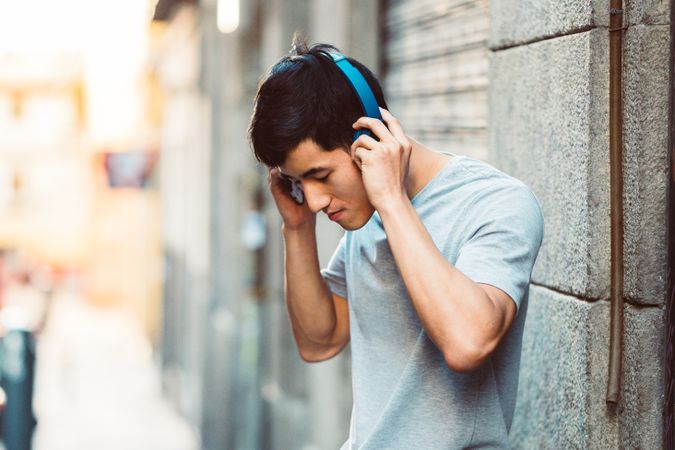 Man in headphones listening music on the street