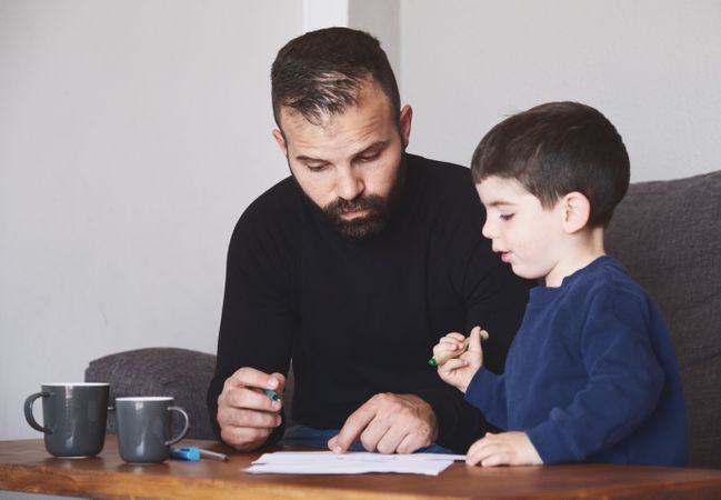 Father and son drawing together
